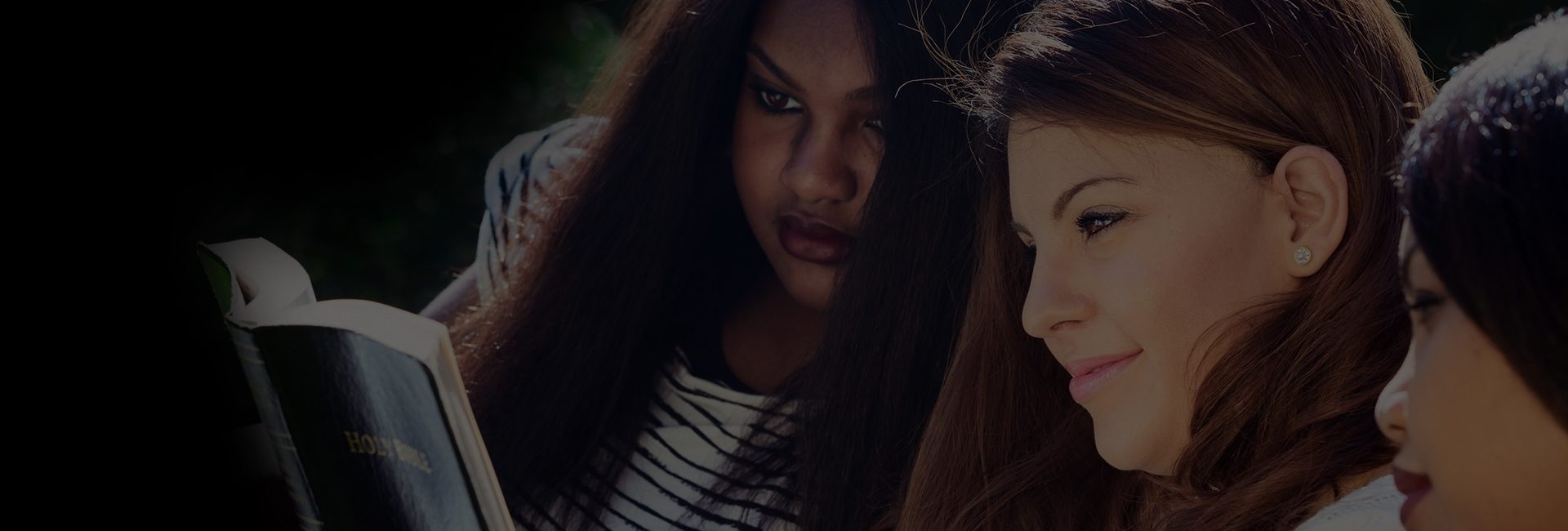 Two women with long hair and one is wearing a striped shirt