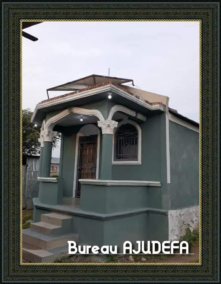 A small house with a balcony and a door.