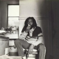 A man sitting in a chair eating something.