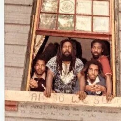 A group of men standing in front of a window.